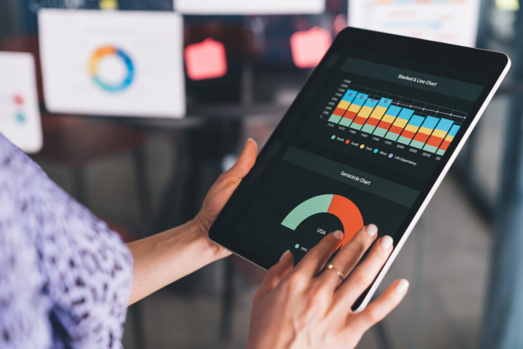 Cropped female employee working with online documents for analyzing graph charts, unrecognizable woman browsing diagram infographics for creating revenue strategy during trade marketing